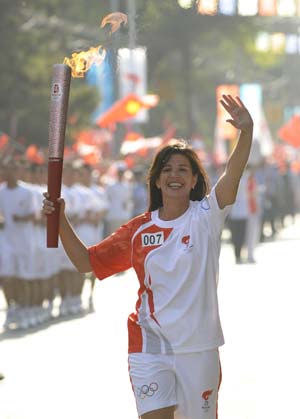 Torchbearer Deirdre Smyth Brady runs with the torch during the 2008 Beijing Olympic Games torch relay in Lanzhou, capital of northwest China's Gansu Province, on July 7, 2008. 