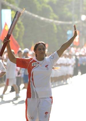 Torchbearer Meena Barot runs with the torch during the 2008 Beijing Olympic Games torch relay in Lanzhou, capital of northwest China's Gansu Province, on July 7, 2008.