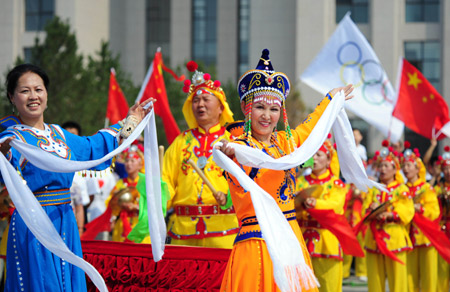 People perform traditional dance to celebrate the 2008 Beijing Olympic Games torch relay in Hohhot, capital of north China's Inner Mongolia Autonomous Region, on July 8, 2008. 