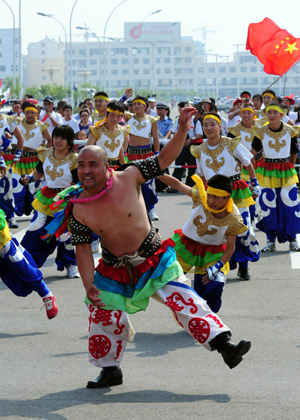 People perform traditional dance to celebrate the 2008 Beijing Olympic Games torch relay in Hohhot, capital of north China's Inner Mongolia Autonomous Region, on July 8, 2008. 