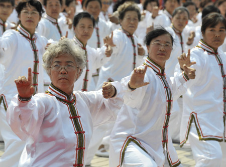 People perform Taiji during the 2008 Beijing Olympic Games torch relay in Hohhot, capital of north China's Inner Mongolia Autonomous Region, on July 8, 2008.
