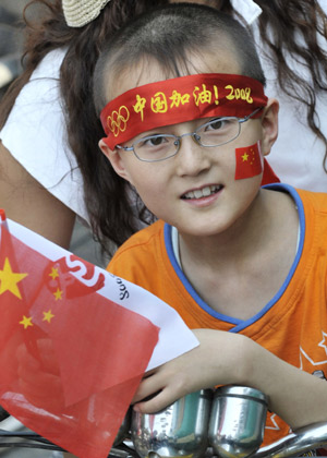 A boy waits for the Olympic torch during the 2008 Beijing Olympic Games torch relay in Hohhot, capital of north China's Inner Mongolia Autonomous Region, on July 8, 2008. 