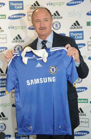 Chelsea's manager Luiz Felipe Scolari poses behind a Chelsea team shirt during a news conference at Cobham in Surrey in southern England, July 8 2008. The former Brazil and Portugal national soccer team manager was officially unveiled today as new Chelsea head coach.