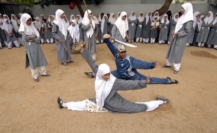 Wushu trainer Rahman Aqeel (C) instructs during Chinese wushu martial arts practice at St. Maaz high school, in the southern Indian city of Hyderabad July 8, 2008. Girls from ages 10 to 16 participate in weekly sessions during school term.