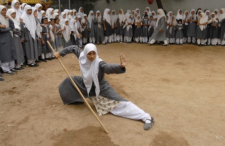 A Muslim schoolgirl from St. Maaz high school practises Chinese wushu martial arts inside the school compound in the southern Indian city of Hyderabad July 8, 2008.