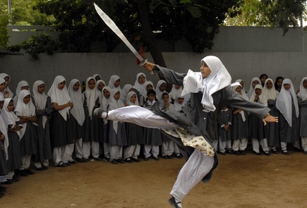 A Muslim schoolgirl from St. Maaz high school practises Chinese wushu martial arts inside the school compound in the southern Indian city of Hyderabad July 8, 2008.