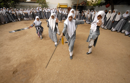 Muslim schoolgirls from St. Maaz high school practise Chinese wushu martial arts inside the school compound in the southern Indian city of Hyderabad July 8, 2008.