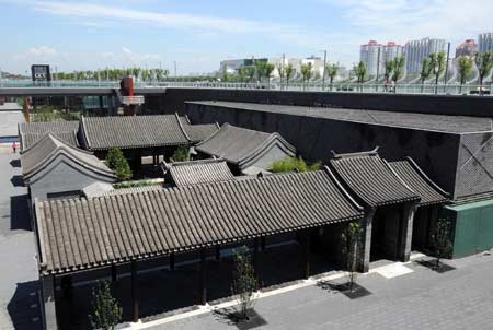 Photo taken on July 6, 2008 shows Chinese courtyard houses at the man-made sinkage square in the Olympic Forest Park in Beijing, capital of China.
