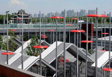 Photo taken on July 6, 2008 shows courtyard houses 'knitted' with pipes at the man-made sinkage square in the Olympic Forest Park in Beijing, capital of China.