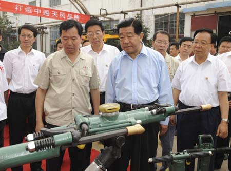 Jia Qinglin (2nd R, front), chairman of the National Committee of the Chinese People's Political Consultative Conference (CPPCC), visits the Tianshui Pneumatic Machinery Co., Ltd in northwest China's Gansu Province, July 8, 2008. Jia made an inpsection tour to northwest China's Shaanxi Province and Gansu Province from July 6 to 10.
