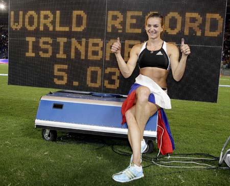 Yelena Isinbaeva of Russia holds her national flag as she celebrates setting a new world record of 5.03 meters in the women's pole vault during the Golden Gala IAAF Golden League at the Olympic stadium in Rome July 11, 2008.