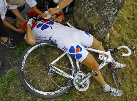 Francaise des Jeux rider Lilian Jegou of France lies on the ground after a crash during the seventh stage of the 95th Tour de France cycling race between Brioude and Aurillac July 11, 2008. Jegou hit a tree and had to pull out of the race with a fractured wrist.