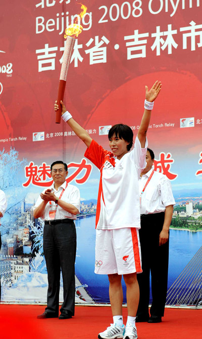 Photo: First torchbearer displays the torch
