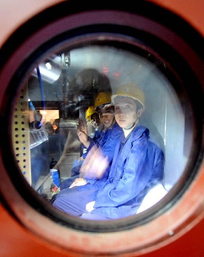 Four staff workers take part in an experiment inside a life-saving capsule on July 2. 