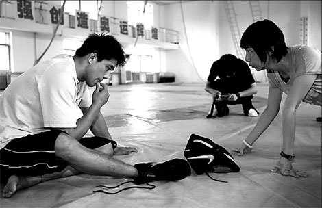A Nike designer talks with a member of the Chinese national wrestling team for feedbacks on his apparel last year in Beiijing.