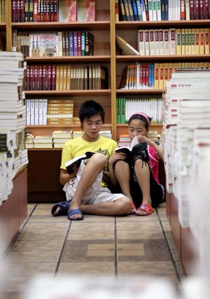 People read books in a bookstore in Shanghai, east China, July 15, 2007. An increasing number of people in Shanghai choose to stay in the the air conditioned bookstores to read books during the summer time. 