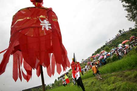 Flags are erected at the hillside to celebrate the Mao Festival in Shui Autonomous County of Sandu, southwest China's Guizhou province, July 14, 2008. 