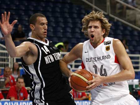 Germany's Dirk Nowitzki (R) is challenged by New Zealand's Craig Bradshaw during their basketball game at FIBA Olympic qualifying tournament in Athens July 16, 2008.