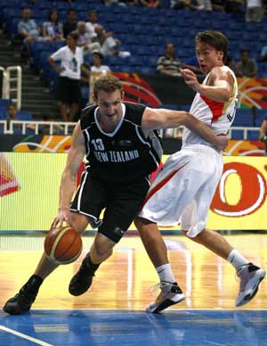 New Zealand's Nick Horvath (L) drives the ball past Germany's Konrad Wysocki during their basketball game at FIBA Olympic qualifying tournament in Athens July 16, 2008.