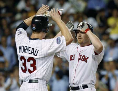 American League All-Star Justin Morneau of the Minnesota Twins (L) congratulates teammate JD Drew of the Boston Red Sox after they scored on Drew's two-run home run in the seventh inning of Major League Baseball's All-Star game at Yankee Stadium in New York July 15, 2008.