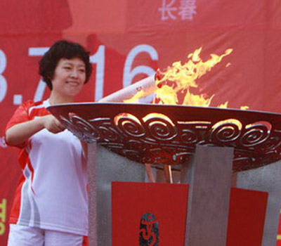 Last torchbearer Xie Jun lights the cauldron during the torch relay in Yanji, Jilin Province, on July 16, 2008.