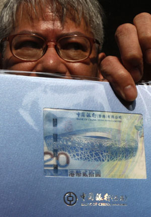 A man shows a special edition HK$20 Olympic banknote released by the Bank of China in Hong Kong July 16, 2008. A man shows a special edition HK$20 Olympic banknote released by the Bank of China in Hong Kong July 16, 2008.