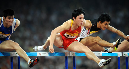 Liu Xiang (C) jumps over a hurdle during the final of the men's 110m hurdles at the Good Luck Beijing 2008 China Athletics Open held at the National Stadium in Beijing, May 24, 2008. Liu Xiang claimed the title of the event with 13 seconds 18.