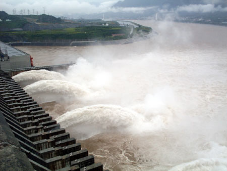 Flood is discharged from the Three Gorges Reservoir through the dam in Yinchang, central China's Hubei Province, July 5, 2008. The Three Gorges Dam Project has started discharging water to lower the water level in the reservoir because of excessive rainfall upstream.