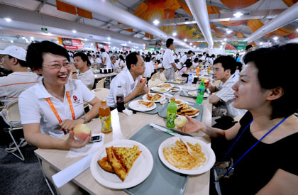Volunteers and staff dine in the Olympic Village in Beijing on July 20, 2008. The village began testing operations on Sunday and will be officially opened on July 27 for the Olympics and Paralympics. [Xinhua]