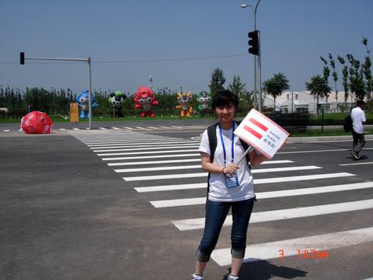 Guess what country am I going to assist during the two-day training? AUSTRIA!!! Here, I’m holding the board with the Austrian flag on it as we are heading to the parking lot to meet our Austrian team. Behind me are the 5 Olympic mascots standing in the scorching hotness of 38 Celsius.