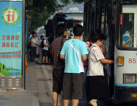 Citizns queue to get on a bus in Beijing, on July 20, 2008. The Chinese capital began on Sunday a two-month-long control of vehicle use to ease traffic pressure and improve air quality for the Olympic Games, set to open in 19 days. 
