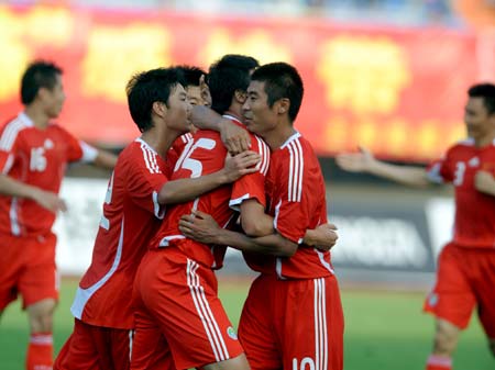 The Chinese men's Olympic football players celebrate for scoring during a warm-up match against their Australian counterparts in Changchun, capital of northeast China's Jilin Province, July 20, 2008. China won 1-0. 
