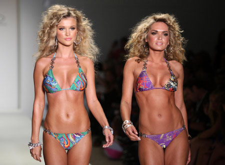 Models walk the runway wearing Ed Hardy swimwear 2009 collection by designer Christian Audigier during Mercedes-Benz Fashion Week Swim show in Miami July 19, 2008. 