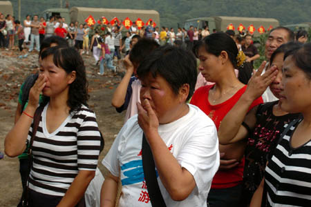 Local residents sob as they bid farewell to the soldiers of Chinese People’s Liberation Army (PLA) in Shifang of southwest China’s Sichuan Province on July 20, 2008. The first batch of PLA soldiers withdraw from the quake-hit city of Shifang on Sunday.