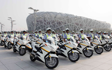 The Beijing Olympic emergency team to deal with traffic situations stands ready in front of the National Stadium or 'Bird's Nest', July 20, 2008. The Olympic transportation security drill was held in the Beijing Olympic area on the same day. [Xinhua] 