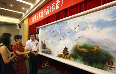 Yao Jianping (C), an embroidery artist and the maker of the embroidery work named “Harmony: A Hundred Year Olympics and a Chinese Dream”, shows her work in Suzhou, east China's Jiangsu province, on July 21, 2008.