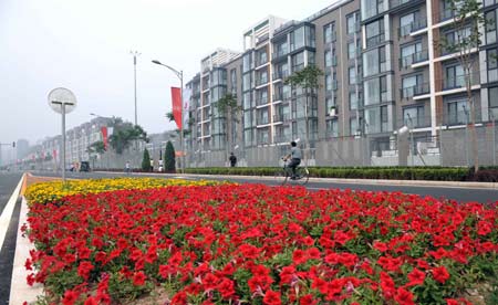 Flowers beautify the surroundings of the athletes' apartments in the Olympic Village in Beijing, capital of China, July 24, 2008. The Olympic Village will be formally opened to the athletes from around the world on July 27. The Beijing Olympic Games will be held on Aug 8-24.