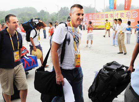 Reporters arrive at the media village for the Beijing 2008 Olympic Games in Beijing, July 25, 2008. The media center opens on Friday to journalists from all around the world.