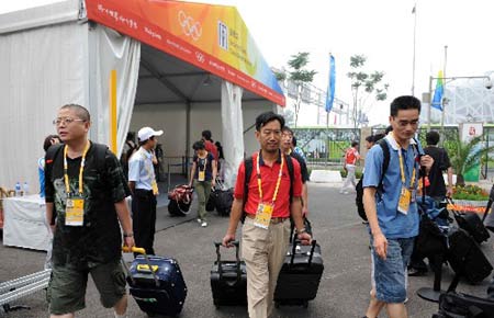 Reporters arrive at the media village for the Beijing 2008 Olympic Games in Beijing, July 25, 2008. 