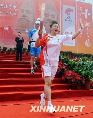 Volleyball player, Zhang Rongfang starts the Olympic torch relay in Zhengzhou, Henan Province July 25.