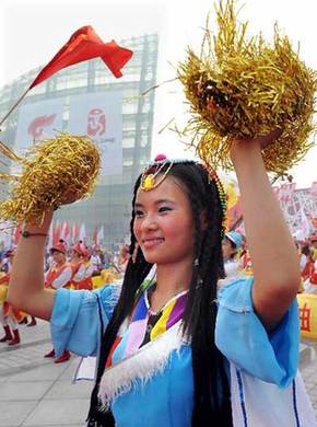 The locals cheers for the torch relay in Zhengzhou, Henan Province July 25.