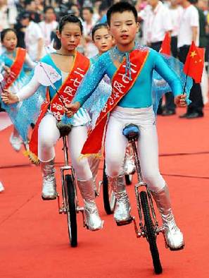 Boys and girls perform acrobatics in the torch relay launch ceremony in Zhengzhou, Henan Province July 25.