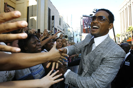 Cast member Will Smith (R) greets fans as he arrives at the movie premiere of 