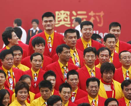Yao Ming (2nd L, top row) smiles wihle posing for a family photo of the Chinese delegation to the Beijing 2008 Olympic Games after the flag-raising ceremony of the Chinese delegation at the Olympic Village, in Beijing, China, July 27, 2008. The Chinese delegation held the first flag-raising ceremony here on Sunday morning after the village officially opened to athletes.