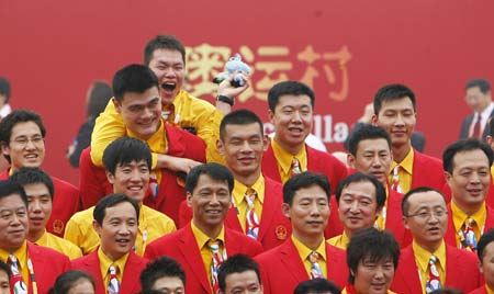 Yao Ming (2nd L, top row), Wang Zhizhi (2nd R, top row), Yi Jianlian (1st R, top row) and Liu Xiang (2nd L, mid row) smile while posing for a family photo of the Chinese delegation to the Beijing 2008 Olympic Games after the flag-raising ceremony of the Chinese delegation at the Olympic Village, in Beijing, China, July 27, 2008. The Chinese delegation held the first flag-raising ceremony here on Sunday morning after the village officially opened to athletes.