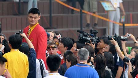 Chinese basketball player Yao Ming receives interviews after the flag-raising ceremony of the Chinese delegation at the Olympic Village, in Beijing, China, July 27, 2008. The Chinese delegation held the first flag-raising ceremony here on Sunday morning after the village officially opened to athletes.