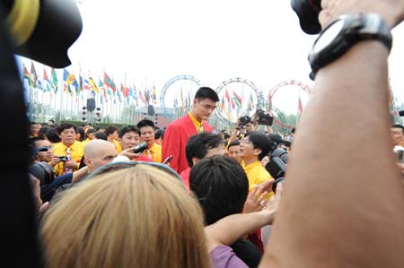 Chinese basketball player Yao Ming (C) attends the flag-raising ceremony of the Chinese delegation at the Olympic Village, in Beijing, China, July 27, 2008. The Chinese delegation held the first flag-raising ceremony here on Sunday morning after the village officially opened to athletes.