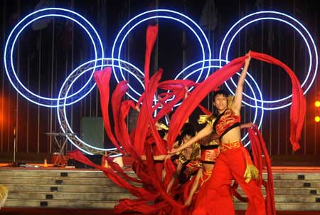 Artists dance during a performance at the Olympic Village in Beijing, capital of China, July 27, 2008. The Olympic Village held the first performance as it opened on Sunday to athletes from all over the world for the Beijing Olympic Games.