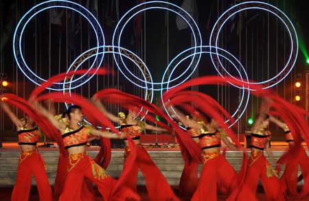 Artists dance during a performance at the Olympic Village in Beijing, capital of China, July 27, 2008. The Olympic Village held the first performance as it opened on Sunday to athletes from all over the world for the Beijing Olympic Games.