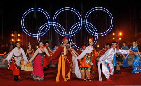 Artists dance during a performance at the Olympic Village in Beijing, capital of China, July 27, 2008. The Olympic Village held the first performance as it opened on Sunday to athletes from all over the world for the Beijing Olympic Games.